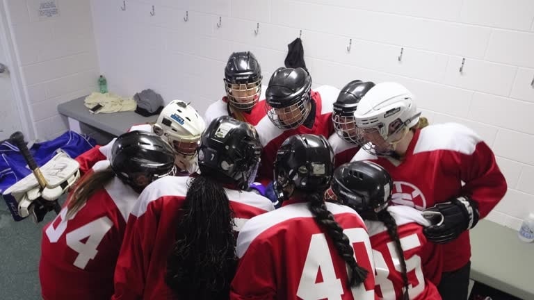Women's hockey team huddle in locker room